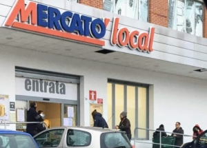 people queue outside a shop