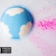 Lush logo. blue bath bomb in pink water signifying an inclusive world event