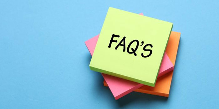 A stack of colorful sticky notes with the top note reading "FAQ'S" in black letters, placed on a blue background—perfect for captioning companies to organize client questions.