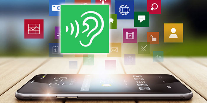 A smartphone with app icons emerging from its screen, featuring a large green icon with an ear symbol in the center, highlights apps for hearing loss.