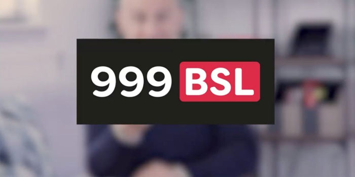 A black box with white text "999" and a red box with white text "BSL"—representing British Sign Language—are centered over a blurred background.