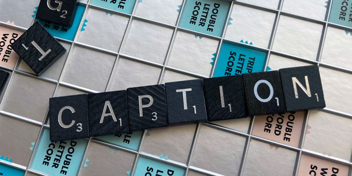 Scrabble tiles spell “CAPTION” on a Scrabble board, covering premium squares like double and triple letter scores—perfect inspiration for clever business captions.