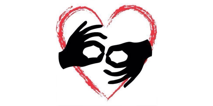 Two black hands forming the "I love you" gesture in sign language, with a red heart outline in the background—symbolizing the vital role of sign language interpreters in bridging communication with love and understanding.