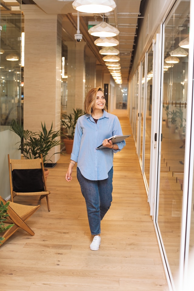 woman walks with laptop